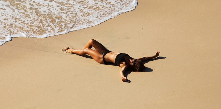 beautiful-girl-relaxing-on-the-wild-beach