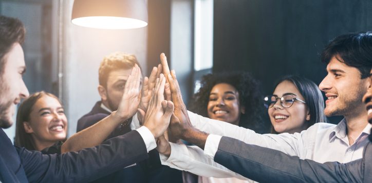 happy-office-workers-giving-high-five-at-meeting