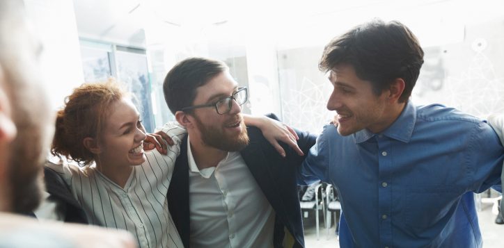 happy-businesspeople-bonding-in-circle-at-company-seminar